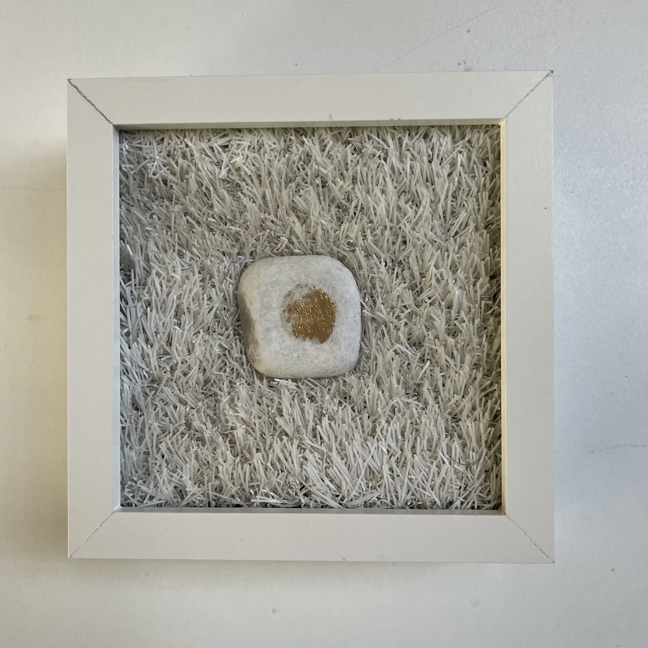 My Milestone – witte kiezel met bladgoud in vitrinekastje, kunstwerk van Sibyl Heijnen